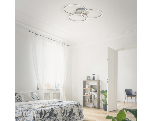 Svetlá spálňa s posteľou a okrúhlym stropným svietidlom