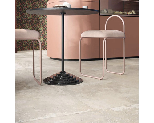 Scéna s dlažbou, okrúhlym stolom a stoličkami.