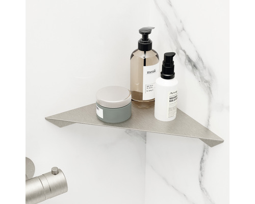 Kovová rohová polica v kúpeľni s kozmetickými produktmi