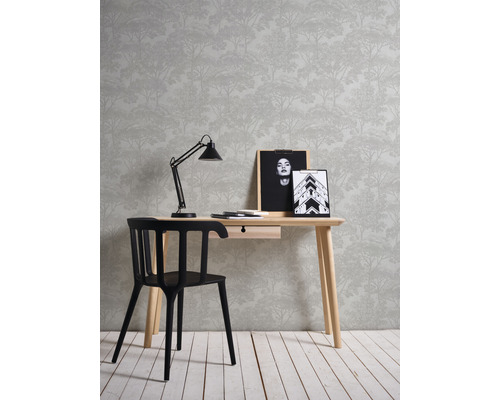 Zariadenie s písacím stolom, stoličkou, lampou, rámčekmi na fotografie a tapetou s motívom lesa.