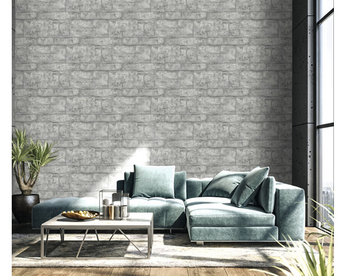 Obývacia izba so sivou tapetou s tehlovým vzorom, pohovkou a rastlinou