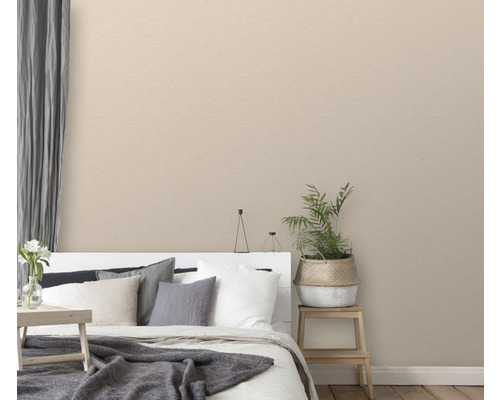 Spálňa s béžovou textilnou tapetou, posteľou a izbovou rastlinou
