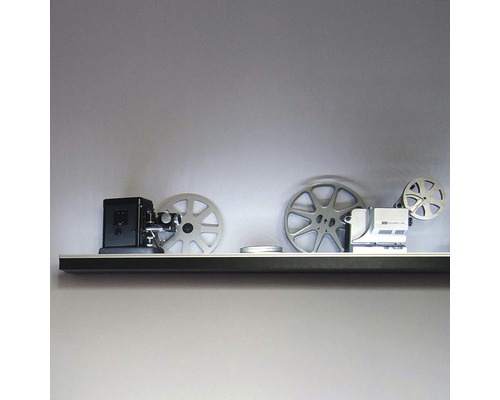 Dekoratívne filmové projektory a filmové kotúče na polici.