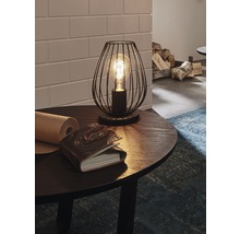 Dekoratívna lampa s klietkovým dizajnom na stole