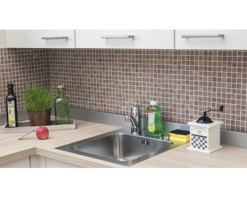 Kuchynský drez s batériou, saponátom, mlynčekom na kávu a dekoráciou na pracovnej doske pred mozaikovými obkladmi