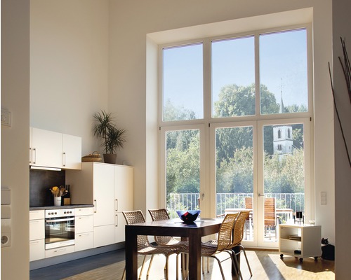 Svetlá obývacia izba s kuchynským kútom, jedálenským stolom a veľkým oknom s výhľadom do zelene