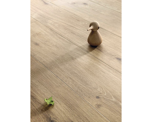 Drevená podlaha s drevenou figúrkou a listom