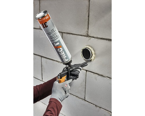 Nanášanie montážnej peny pomocou penovej pištole na stenu