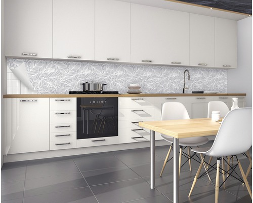 Moderná kuchyňa s bielou kuchynskou linkou, jedálenským stolom a nástennými panelmi s listovým vzorom