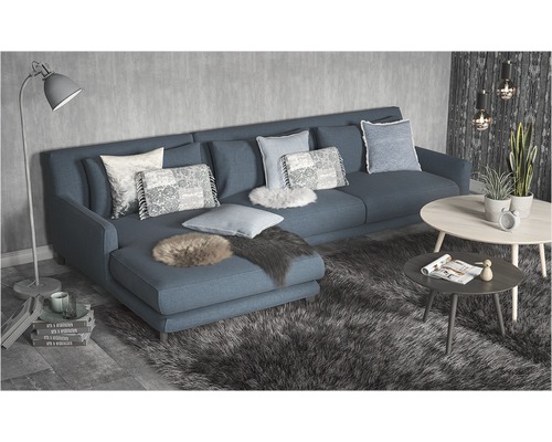 Obývacia izba s rohovou sedačkou, vankúšmi, kobercom a konferenčnými stolíkmi