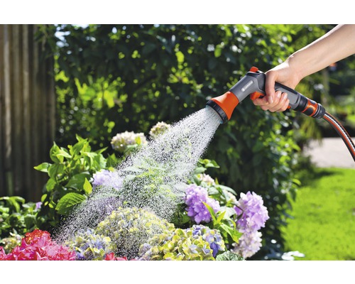 Zavlažovanie záhrady ručnou sprchou na záhradnej hadici