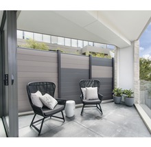 Balkón s dvoma stoličkami, vankúše, malý stolík, rastliny a plot