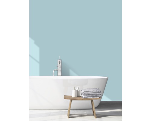 Svetlá kúpeľňa s voľne stojacou vaňou, batériou, uterákmi a drevenou lavicou