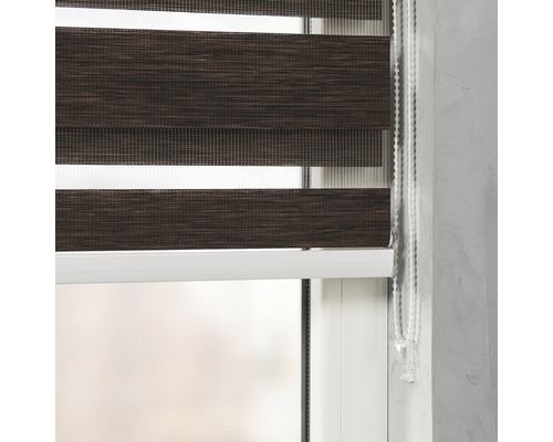 Detailný záber hnedej dvojitej rolety na okne s ovládacou retiazkou