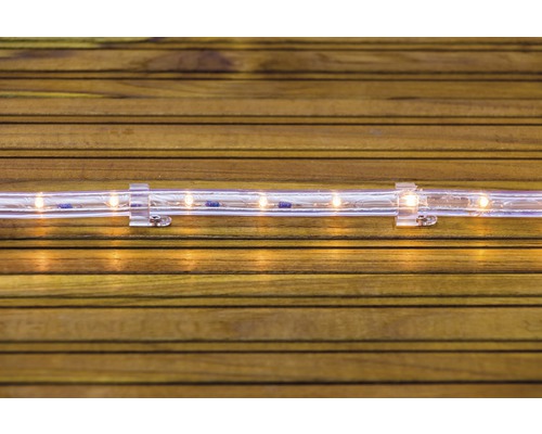 LED svetelný had s držiakom na drevenom pozadí