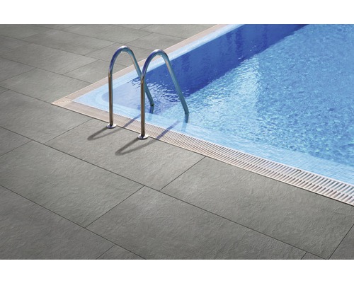 Bazén so sivými terasovými dlaždicami a nerezovým rebríkom