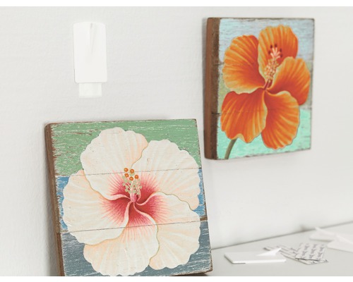 Dva drevené obrazy s kvetinovými motívmi a upevňovací háčik na stene