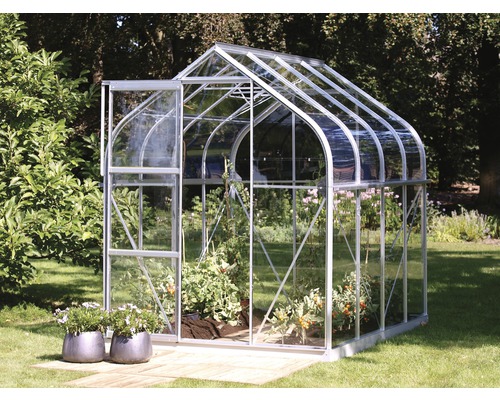 Skleník s rastlinami v záhrade.