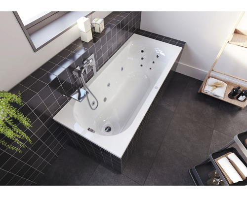 Vstavaná vaňa s funkciou vírivky, armatúrou a obkladmi v kúpeľni.