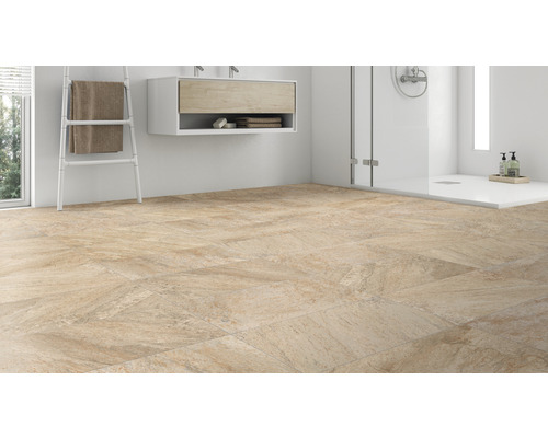 Kúpeľňa s dlažbou, umývadlom a sprchou.