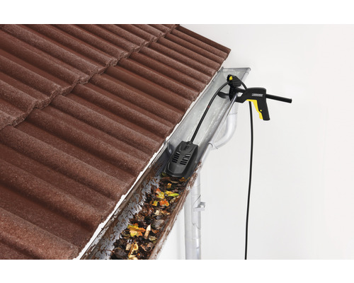 Čistič odkvapov v akcii na odstránenie lístia a nečistôt z odkvapu