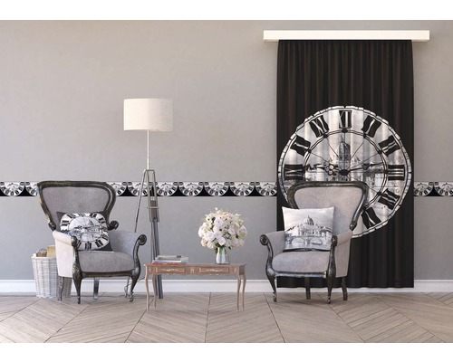 Obývacia izba s dvoma kreslami, stolom, stojacou lampou, bordúrou a závesom s motívmi hodín.
