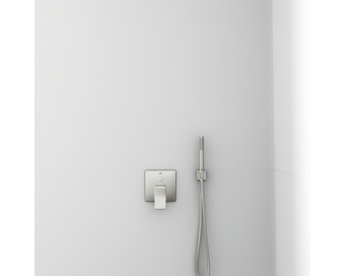 Sprchová batéria a ručná sprcha na bielej stene