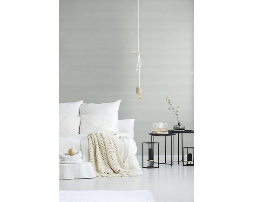 Svetlo zariadená spálňa s posteľou, príručnými stolíkmi a lampou