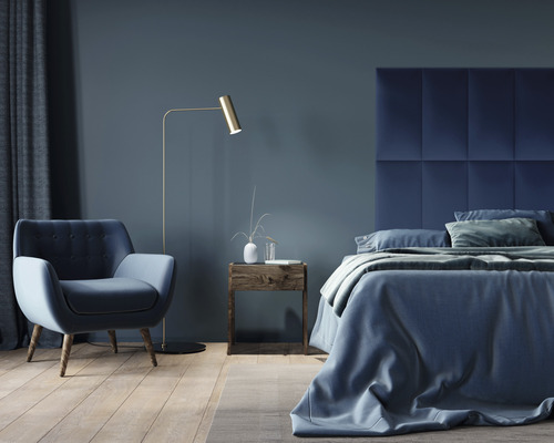 Spálňa s posteľou, kreslom, stojacou lampou a nočným stolíkom