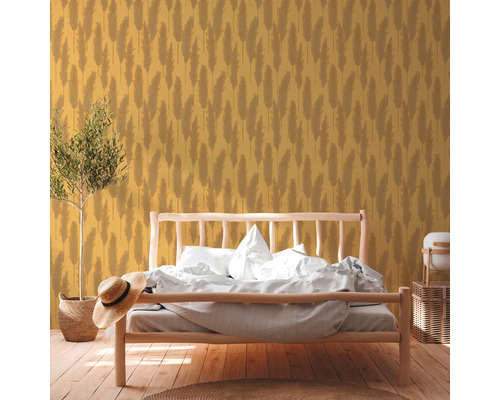 Spálňa s drevenou posteľou a žltou tapetou s rastlinným vzorom