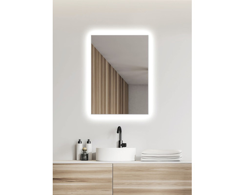 Osvetlené obdĺžnikové zrkadlo do kúpeľne nad umývadlom s umývadlovou doskou.