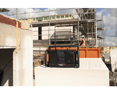 Stavebné rádio značky Perfectpro na pozadí staveniska