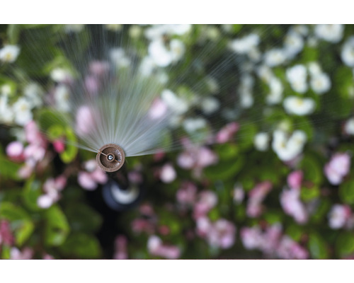 Zavlažovací systém v prevádzke pred kvetinovým záhonom