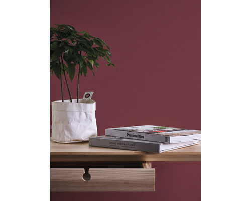 Dekoratívne aranžmán s izbovou rastlinou v papierovom obale, knihami a dreveným písacím stolom