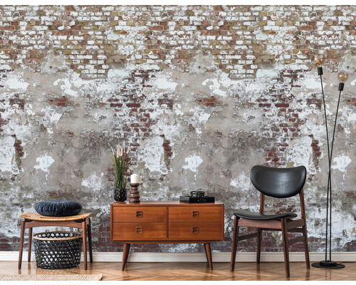 Dekoratívna obývacia izba s tapetou z tehál, komodou, stoličkou a stojacou lampou.