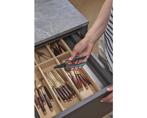 Osoba vyberá nožnice na kvety Gardena zo zásuvky s príbormi.