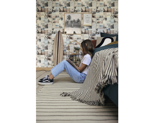 Dekoratívna izba s fototapetou, surfovou doskou, kobercom a osobou, ktorá číta.