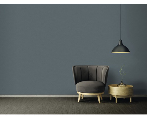 Obývacia izba s kreslom, stolom a závesnou lampou