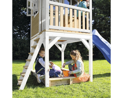 Hrací veža so šmykľavkou a pieskoviskom s hrajúcimi sa deťmi v záhrade.