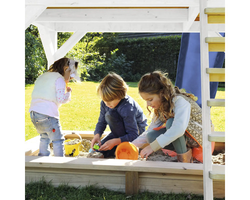 Deti sa hrajú v pieskovisku so strieškou na ihrisku.