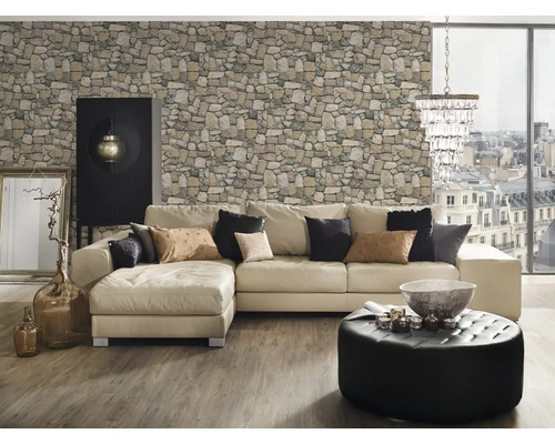 Obývacia izba s rohovou sedačkou, kamennou tapetou, otomanskou stoličkou, skriňou a dekoráciami.