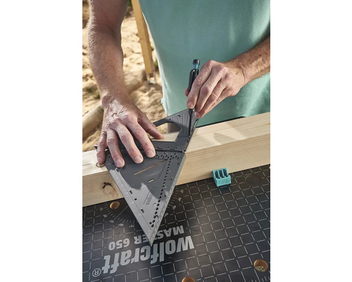 Osoba používa uholník na označenie drevenej dosky.