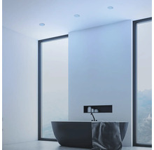 Moderná kúpeľňa s vaňou, oknom a zapustenými stropnými svetlami