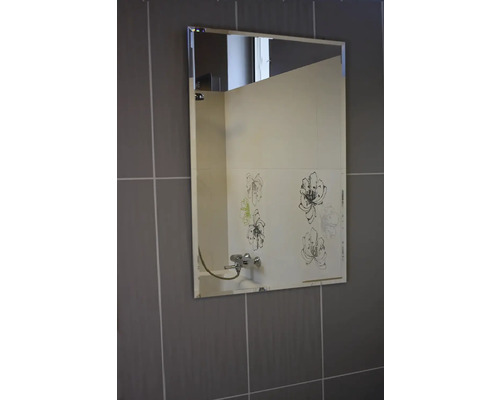 Obdĺžnikové zrkadlo na stene s dlaždicami