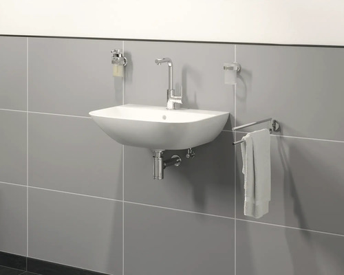 Kúpeľňové umývadlo s batériou, dávkovačom mydla, pohárom na zubné kefky a držiakom na uteráky na obkladanej stene