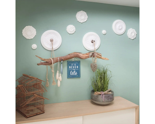 Dekoratívna nástenná dekorácia s kvetinovými štukovými prvkami, konár ako vešiak, dekorácia s múdrosťou a dekorácia na komode s klietkou a rastlinou