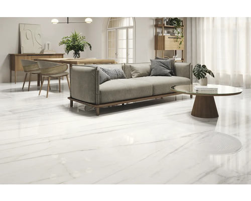 Svetlá miestnosť s pohovkou, stolom a lesklou podlahovou krytinou s mramorovým vzhľadom