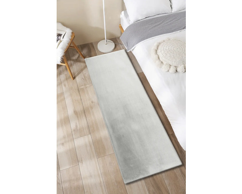 Koberec v spálni s posteľou, stoličkou a stojacou lampou