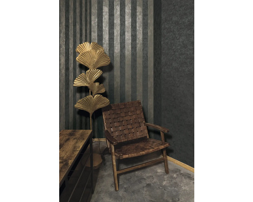 Ukážka interiéru s kreslom, komodou a stojacou lampou pred pruhovanou tapetou