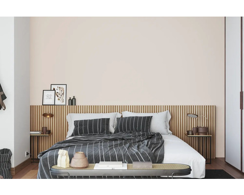 Spálňa s posteľou, nočnými stolíkmi a dekoratívnymi prvkami.